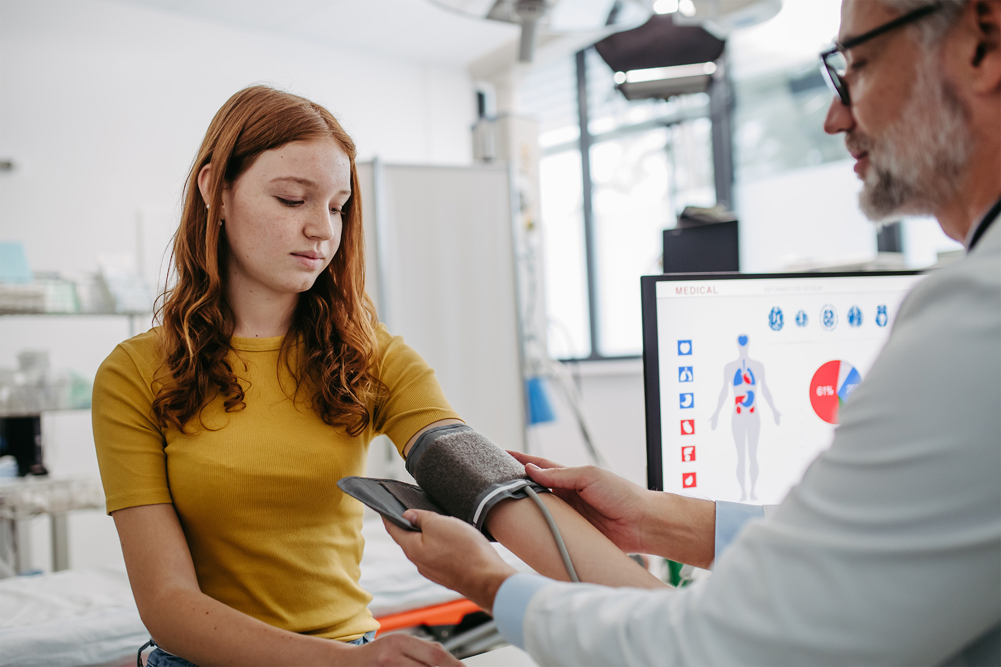 A healthcare provider is checking a patient's blood pressure. A healthcare provider is checking a patient's blood pressure.